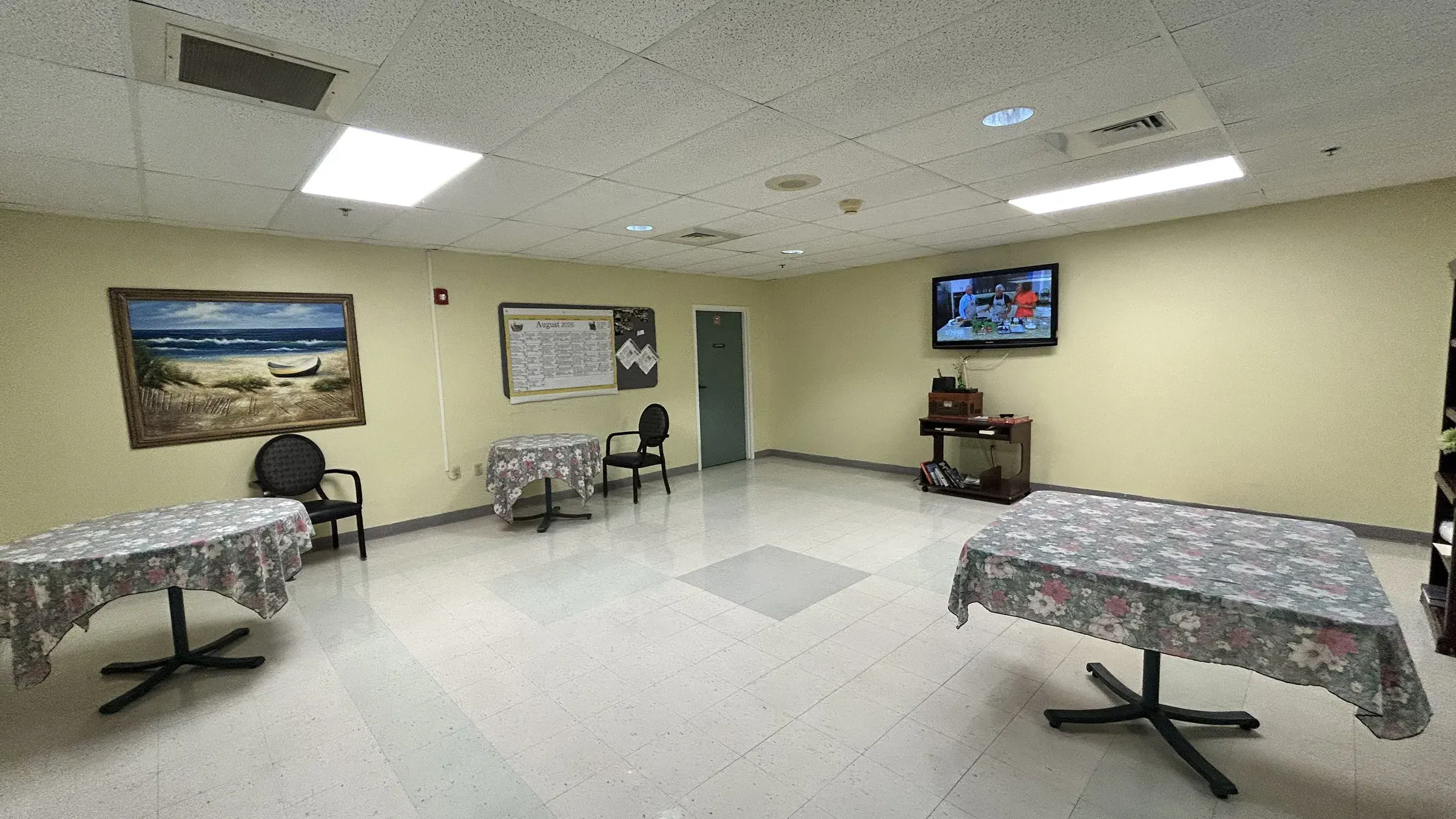 An activity room at Vivo Healthcare Harbourwood, tables dressed for the afternoon