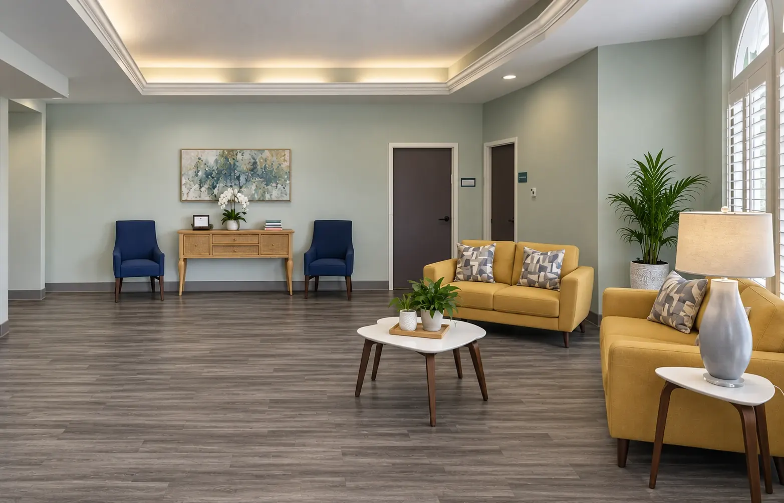 A lounge at Vivo Healthcare Harbourwood, with yellow sofas around a low table